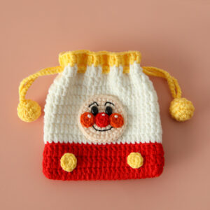 A handmade knitted bag featuring an adorable Anpanman face, perfect as a crochet gift bag for kids.