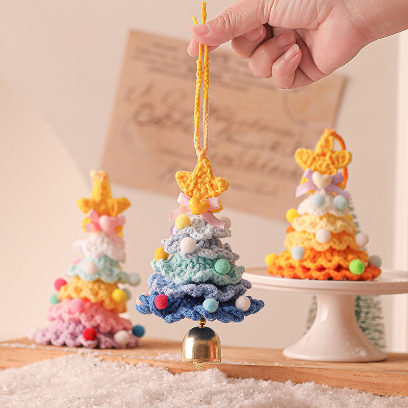 Colorful handmade crochet Christmas tree ornaments with small bells at the bottom, perfect for Christmas decorations.