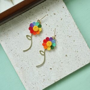Colorful handmade crochet floral earring studs from a mini crochet factory, featuring rainbow petals and slender stems—perfect thoughtful gifts or bohemian accessories