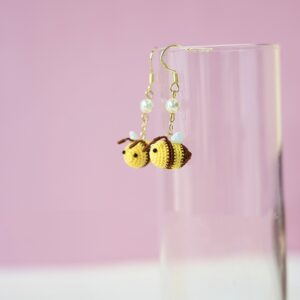 Adorable handmade crochet bee earrings with pearl accents, crafted by a micro-crochet factory. Perfect crochet jewelry for gift-giving.
