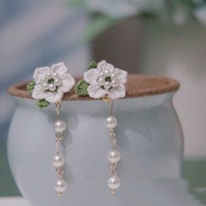 Handmade white crochet floral earrings studs featuring delicate micro-crochet flowers and pearl drops, perfect crochet jewelry for women.