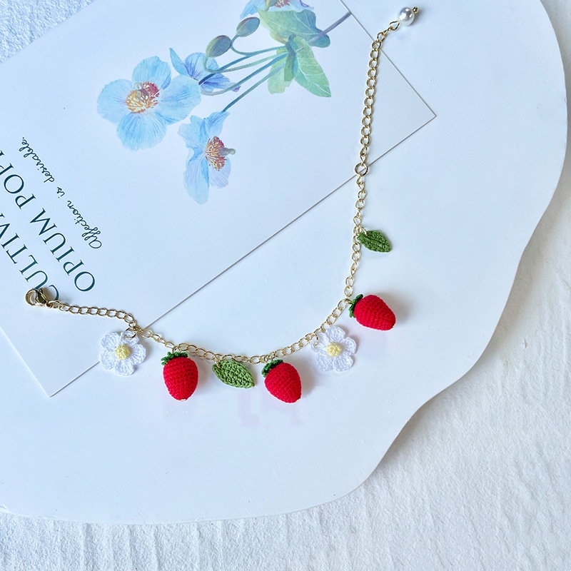 Vibrant handmade crochet bracelets featuring strawberry and floral charms, ideal for wholesale crochet jewelry suppliers